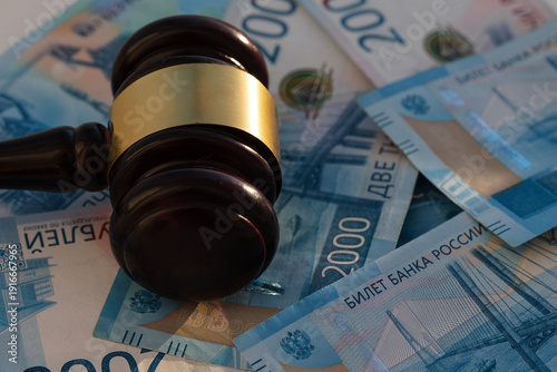 Two thousan rubles banknotes and wooden gavel close-up