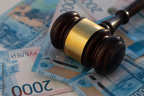Two thousan rubles banknotes and wooden gavel close-up