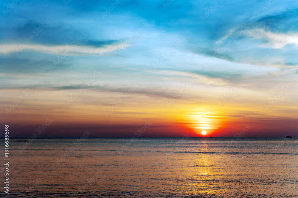 Fototapeta premium A beautiful colorful blue-orange sunset over the Gulf of Thailand in Vietnam. Desktop wallpaper. Nature. Travel concept.