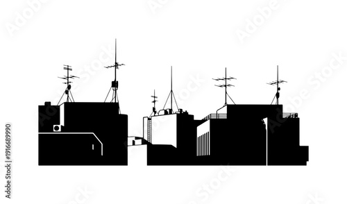 Cityscape silhouette with various rooftops and antennas