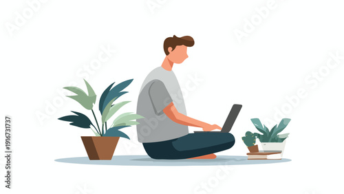 A person sits cross-legged on the floor, working on a laptop, surrounded by plants