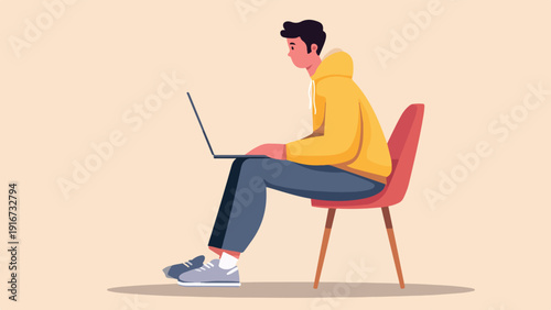 Person in yellow hoodie and blue pants on a red chair using a laptop