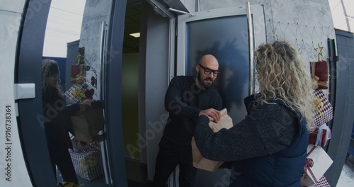 Obraz na plátně Courier With Large Delivery Backpack Arrives at House and Rings Doorbell