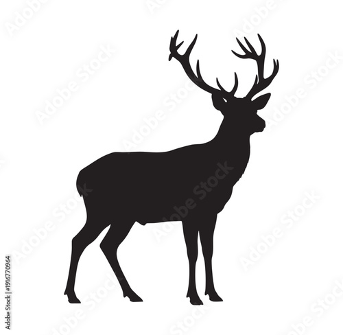 black silhouette of a deer with large antlers standing alone