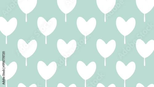 Cute pattern of white heart shaped trees on a soft mint green background creates a whimsical and romantic forest landscape design.