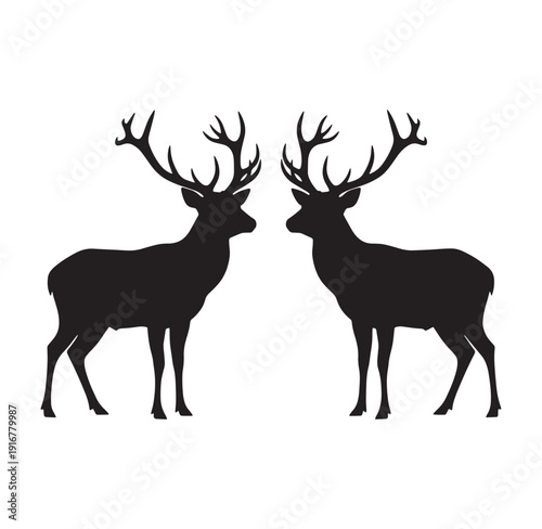 Two deer with large antlers standing face to face in profile