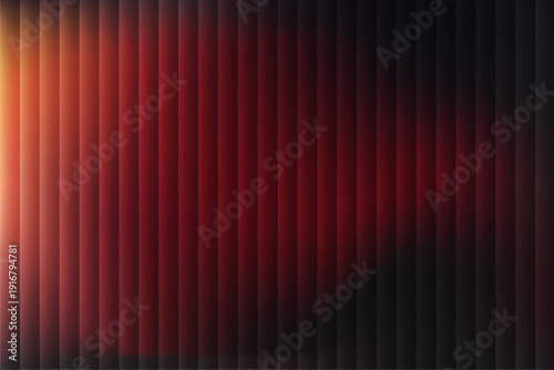 A dramatic red curtain with vertical folds illuminated by a bright light from the left side, creating a striking contrast of light and shadow in a theatrical setting.