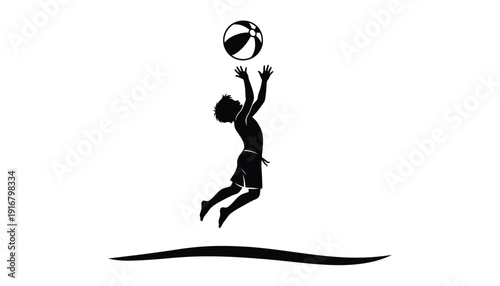 Silhouette of a young boy jumping high to catch a beach ball.