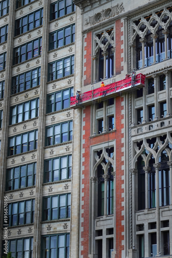 Fototapeta premium Men on Elevated Platform Washing Windows on Skyscraper or Highri