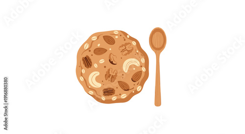 A large, round oatmeal cookie topped with various nuts and grains, positioned next to a simple wooden spoon.