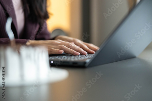 Slika na platnu A focused individual typing on a laptop keyboard, emphasizing productivity and modern work culture