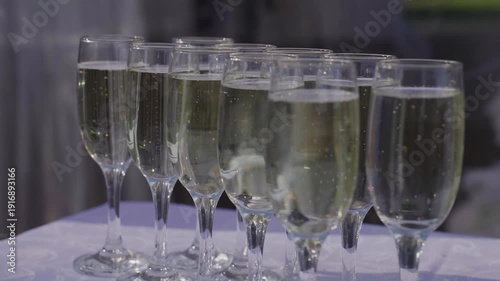 Glasses of champagne on the street, slow motion