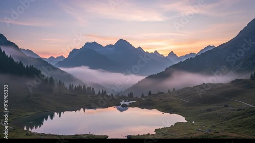 Serene Mountain Lake at Sunrise with Misty Valleys and Reflecting Peaks.