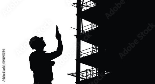 Silhouette of construction worker in hard hat inspecting tall scaffolding structure against bright background