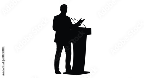 Silhouette of a business man giving a presentation from behind a modern podium with microphones