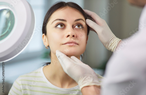Foto Surgeon touching woman face consulting before rhinoplasty operation