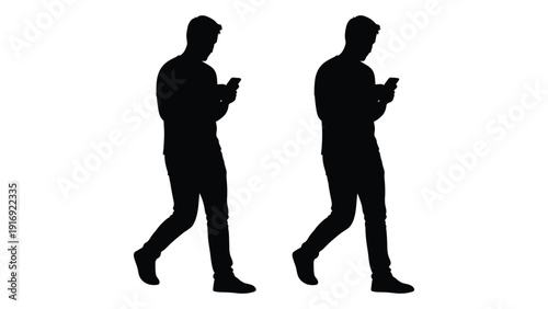 Two silhouetted figures walking and using their mobile phones high quality