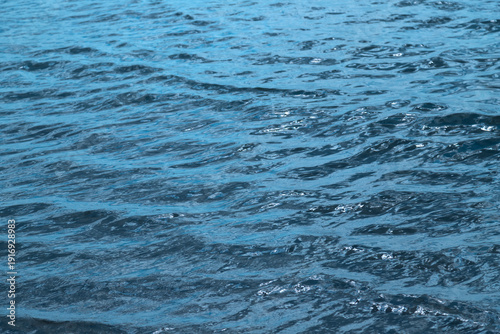 Calm rippling ocean water with gentle waves and deep blue sea surface texture