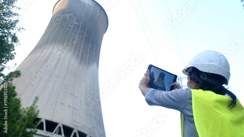 Quadro su tela Woman engineer in hard hat and safety vest conducts digital tablet inspection of