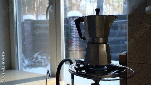 Coffee brewing on a gas stove during a power outage. Close-up of a pot heating over an open flame in a kitchen without electricity, highlighting everyday adaptation and resilience during an energy cri
