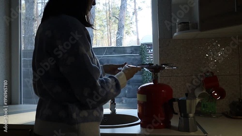 Young Ukrainian Woman Lighting Gas Stove to Make Coffee During Blackout