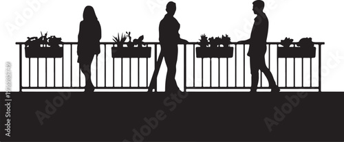 Three silhouettes walking past a railing with planters