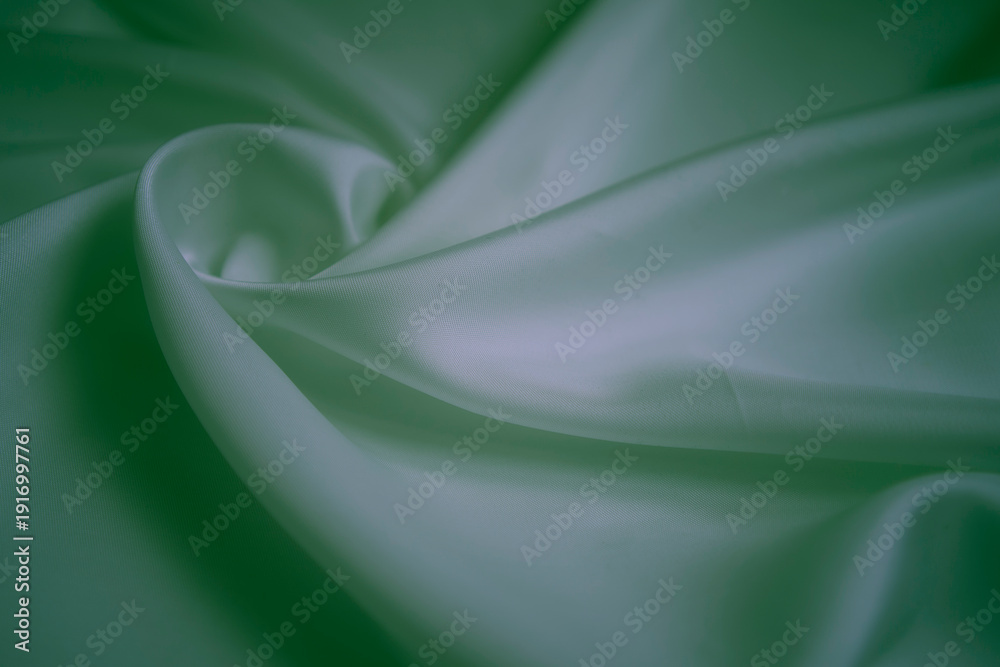 Obraz premium White silk fabric with neon green reflections and elegant swirls