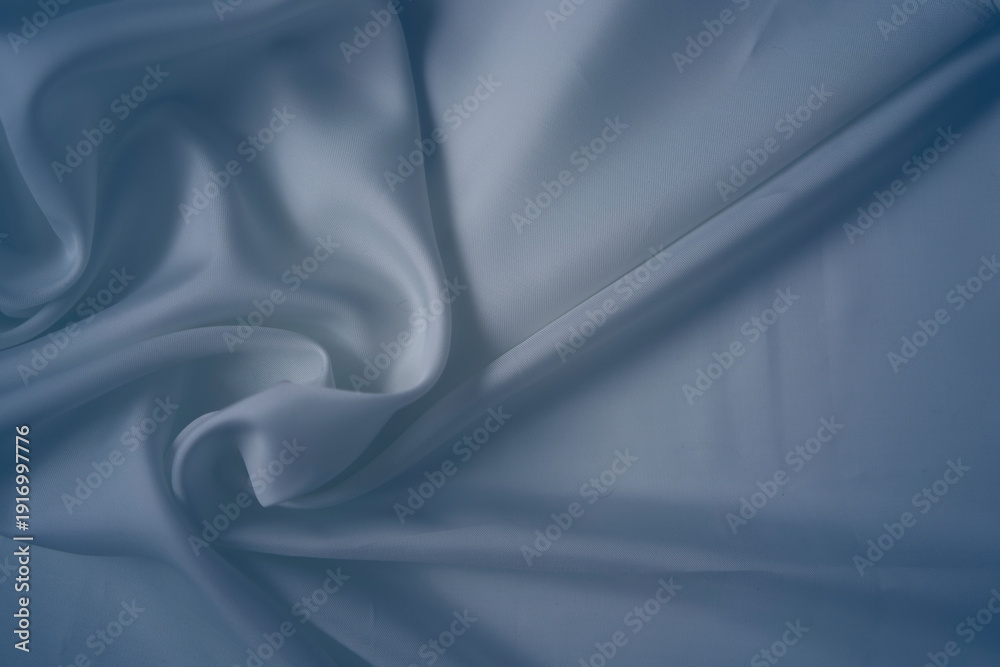 Obraz premium White and cashmere blue silk fabric with elegant flowing folds