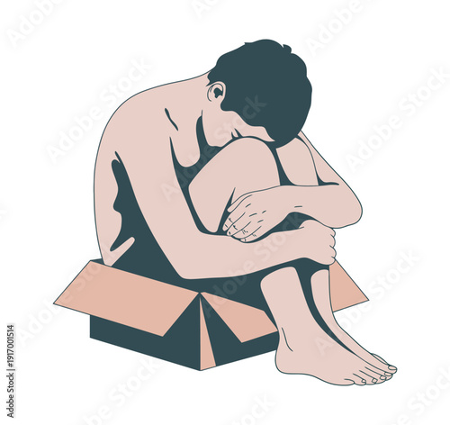 A man sits alone in a cardboard box, conveying a sense of sadness and isolation.