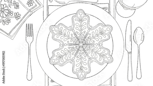 A decorative snowflake cookie is placed on a dinner plate with cutlery and a napkin