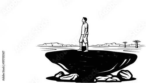 Man stands on dark rock overlooking a savanna with mountains and baobab trees