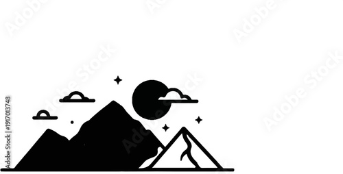 Silhouette of mountains under a dark moonlit sky with clouds and stars