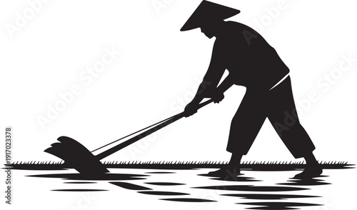 Silhouette of a person plowing a field with a traditional tool