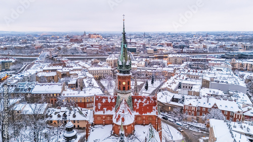 Aerial view of St. Joseph's Church and the evening panorama of Krakow in winter, Poland