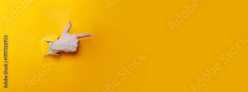 Index Finger Pointing Through Ripped Yellow Paper, Casual Confident Gesture, Communication Cue For Pitch
