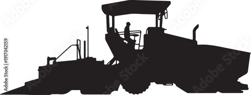 Silhouette of a person operating a road construction machine