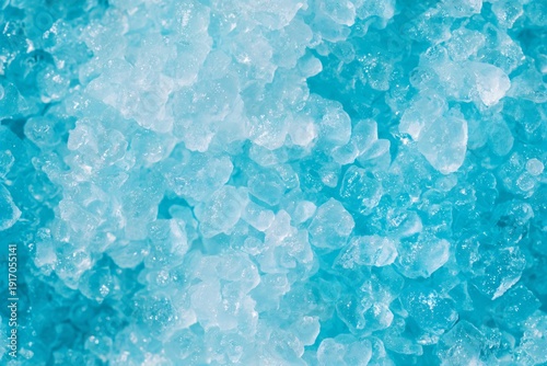 Close up of shiny clear blue sugar crystals. Food texture and seamless pattern for sweet candy products. Abstract food background.