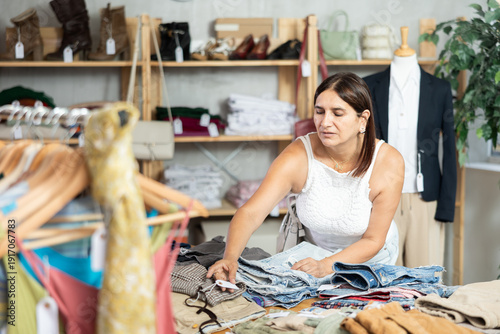 Tableau sur toile Woman view assortment in clothing department, buying lady trousers