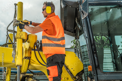 Construction Worker Operates Machinery at Site