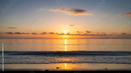 Golden Sunset Over Calm Ocean Waves on Sandy Beach.
