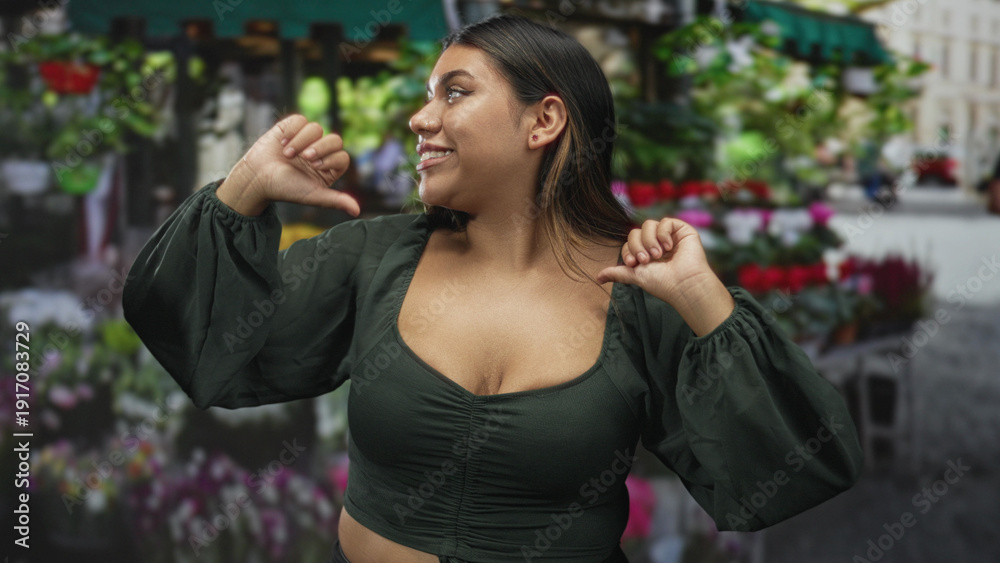 Fototapeta premium Woman shrugs hands, exposed chest at a bustling street flower market while smiling and posing amid bouquets; playful ease.