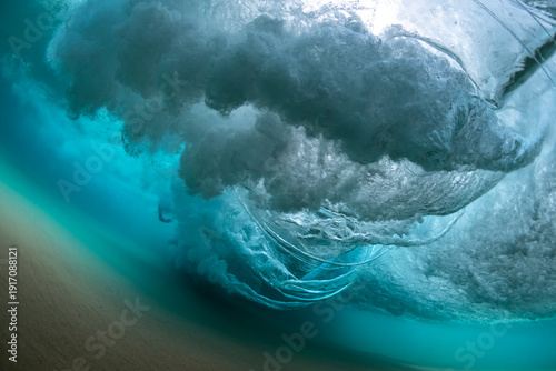 Powerful underwater wave breaking over sandy seabed at Bondi Beach, Sydney, Australia, showing turbulent water, air bubbles, and motion beneath the ocean surface.