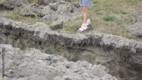 Wallpaper Mural Little girl jumps over an earthen ditch Torontodigital.ca