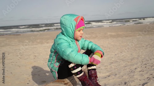 Wallpaper Mural Little beautiful sad girl sits about sea Torontodigital.ca