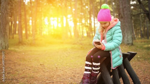 Wallpaper Mural Beautiful smiling little girl with mobile phone Torontodigital.ca