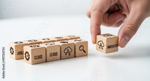 Wooden cubes representing digital transformation ideas arranged by hand with crisp macro detail and smooth white blur behind.