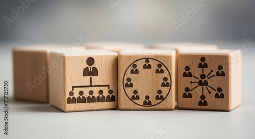 Wooden cubes representing leadership arrangements placed using shallow focus and neutral soft blurred background.