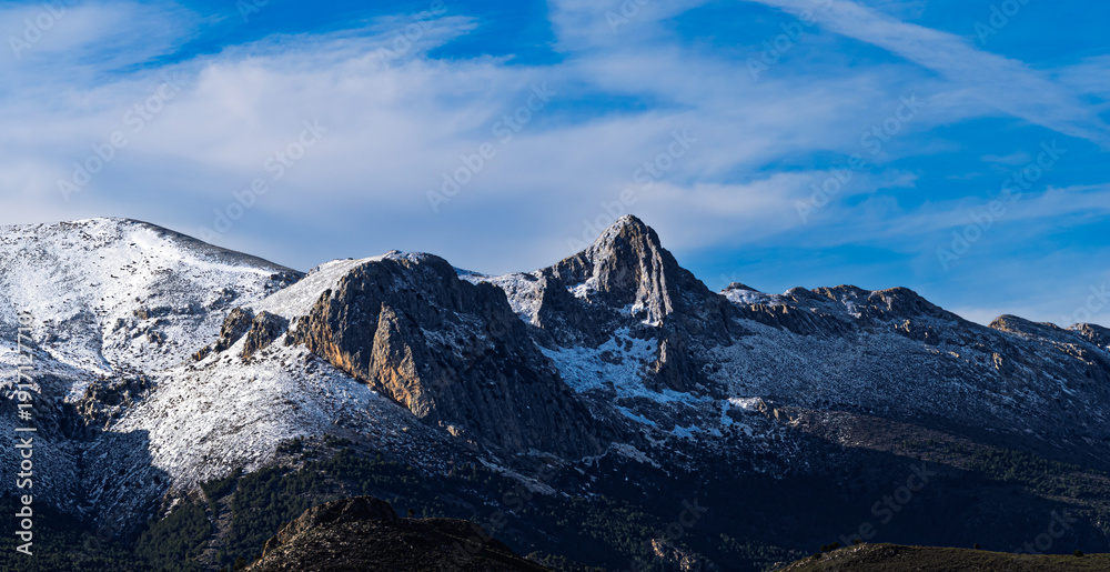 Obraz premium View of the snow-capped Sierra Arana mountains in Granada, Spain