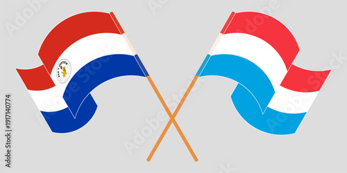 Crossed and waving flags of Republic of Paraguay and Luxembourg