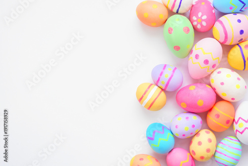 Colorful Easter Egg side border against a white background. Overhead view with copy space.